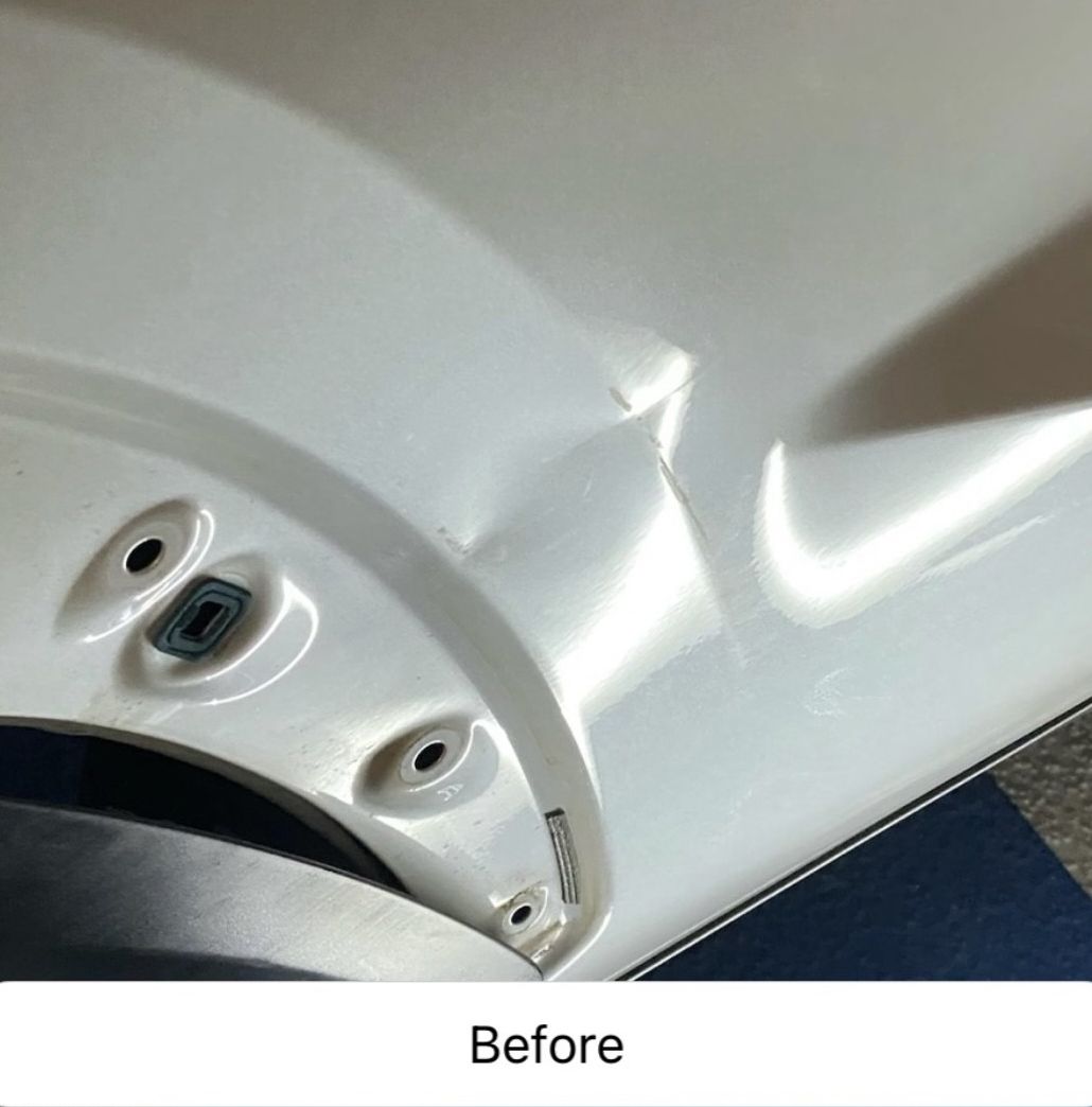 Close-up of a white car panel with dents and scuffs near the wheel arch, labeled “Before”