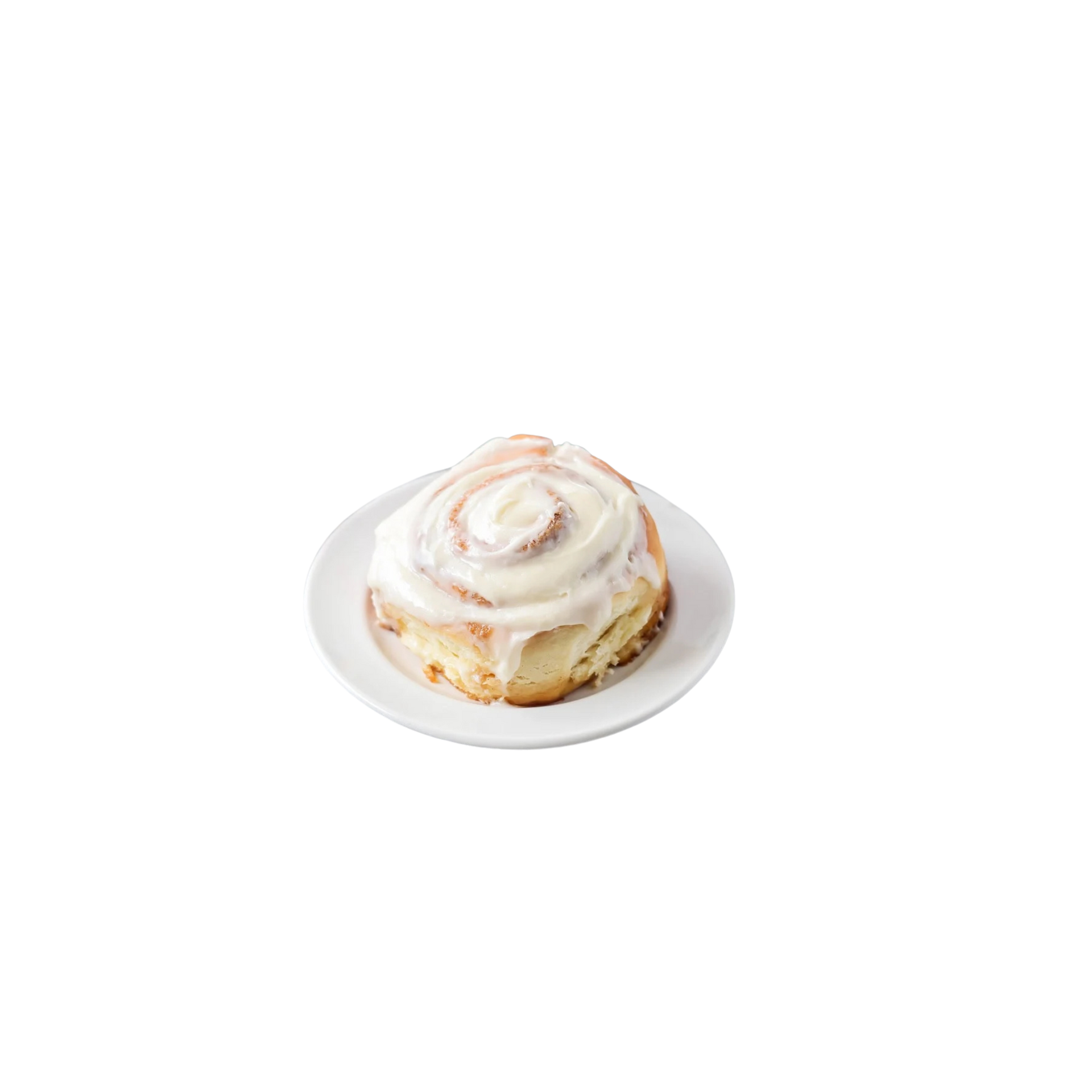 Cinnamon roll with white icing on a white plate
