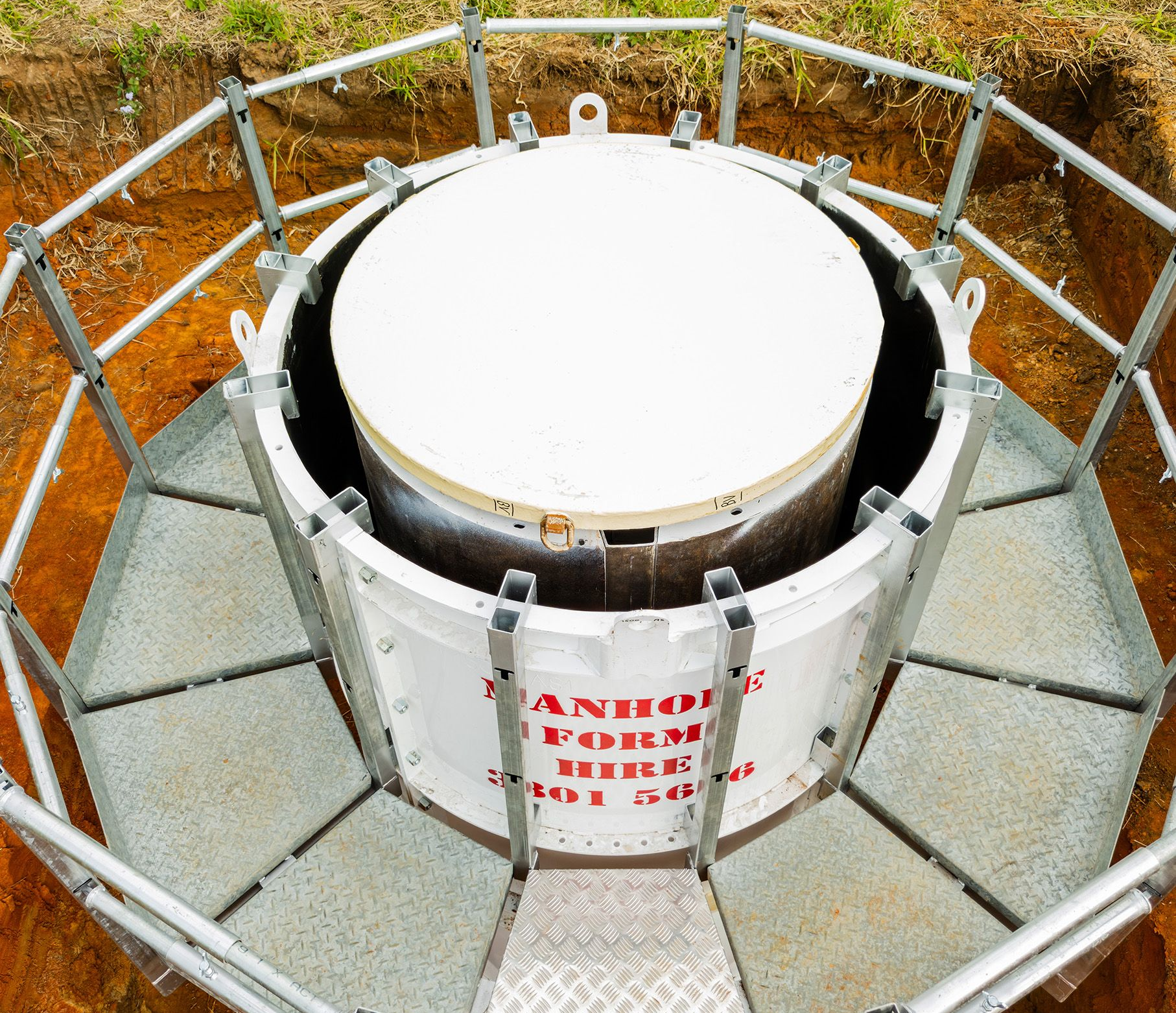 Pour board on manhole drum with scaffold