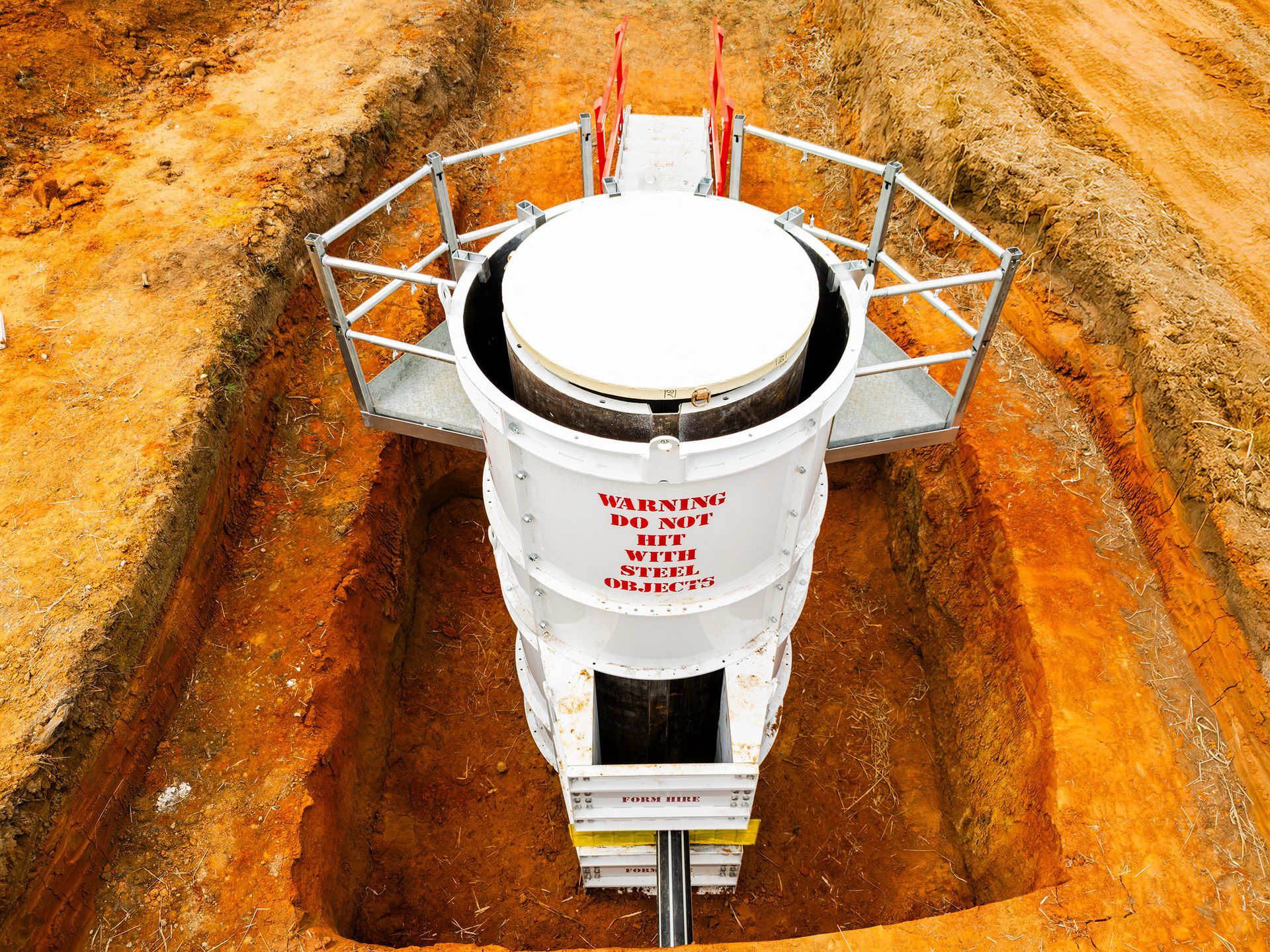 Manhole drum with backdrop, half scaffold and pour board
