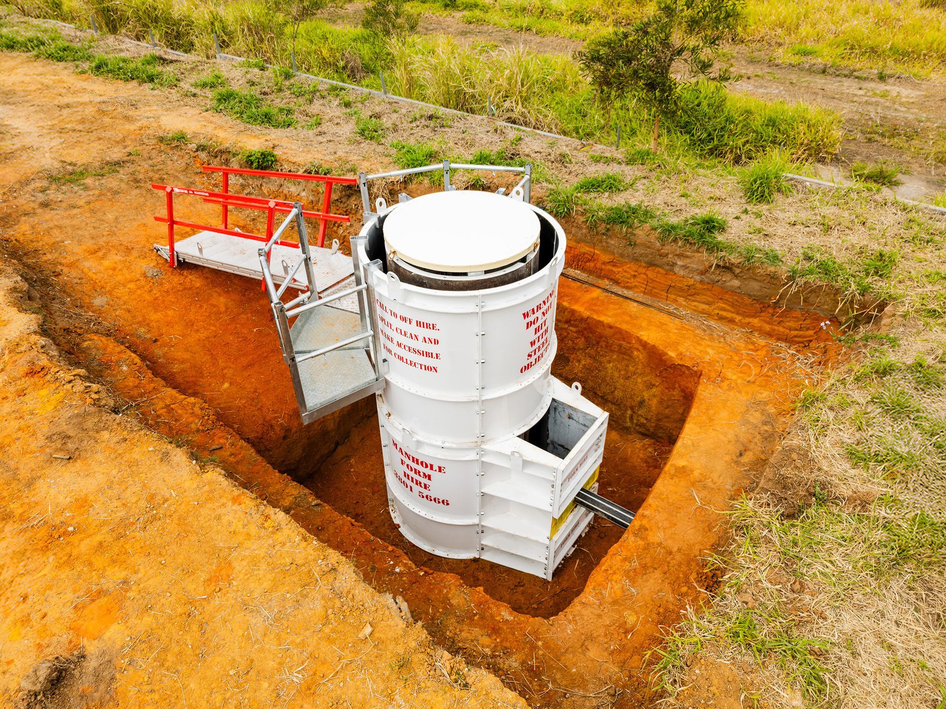 Manhole forms with backdrop, pour board, half-scaffold and stairs