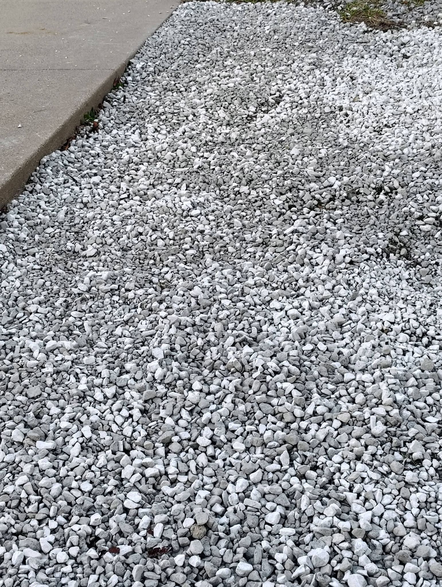 Gray gravel path beside a concrete curb