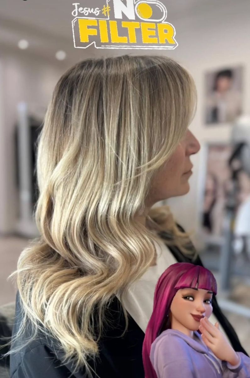 Capelli biondi ondulati su un manichino, con una piccola bambola dai capelli viola in primo piano.