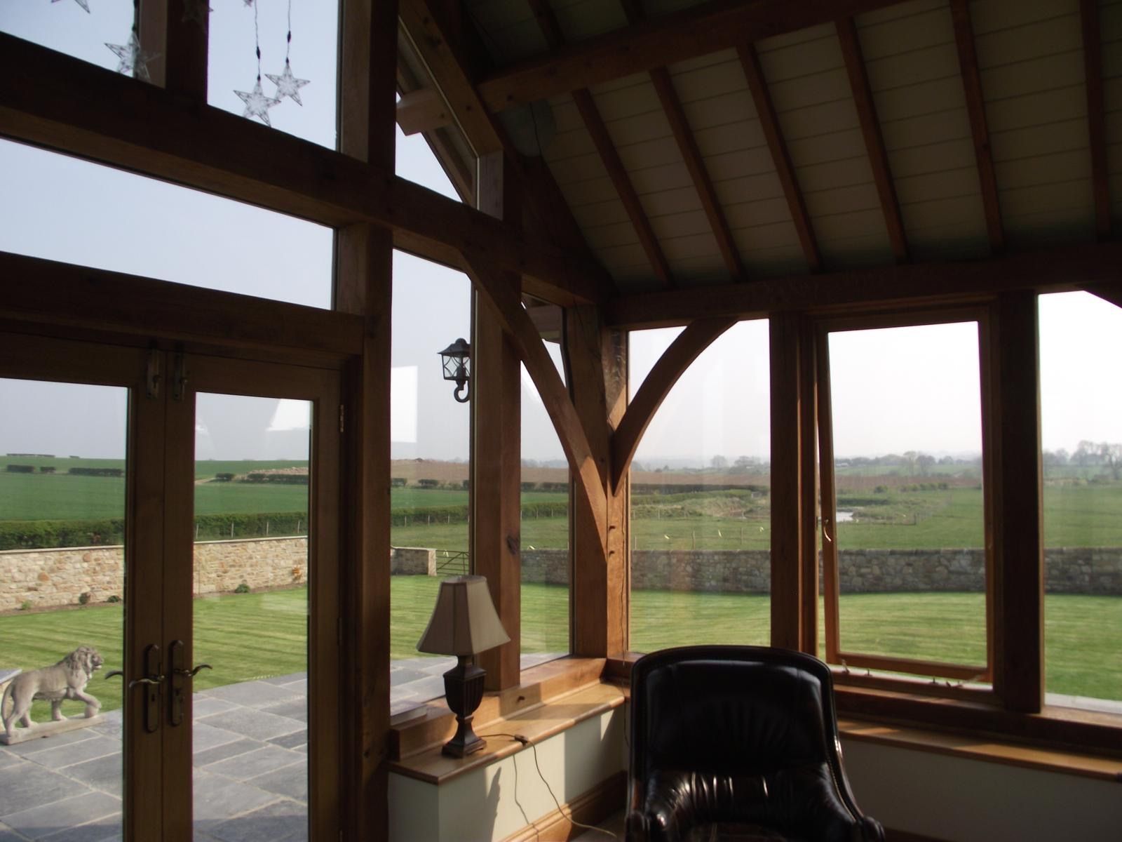 A room with a lot of windows and a chair