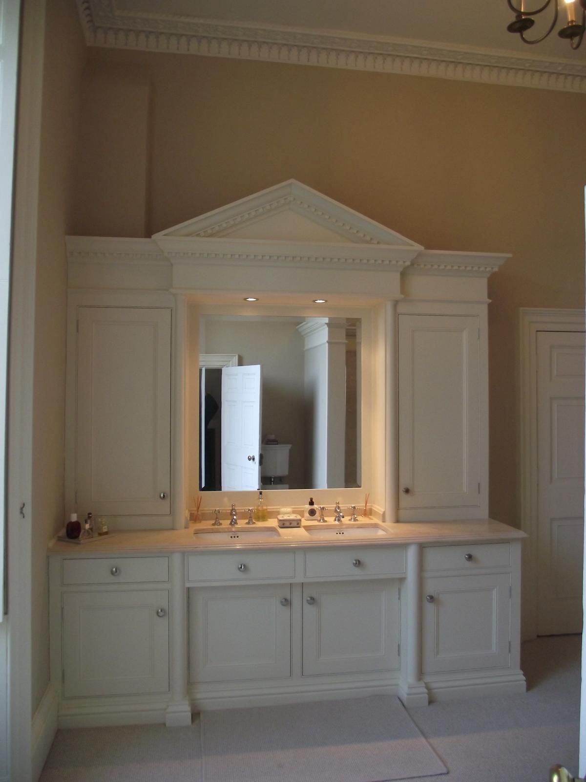 A bathroom with two sinks and a large mirror