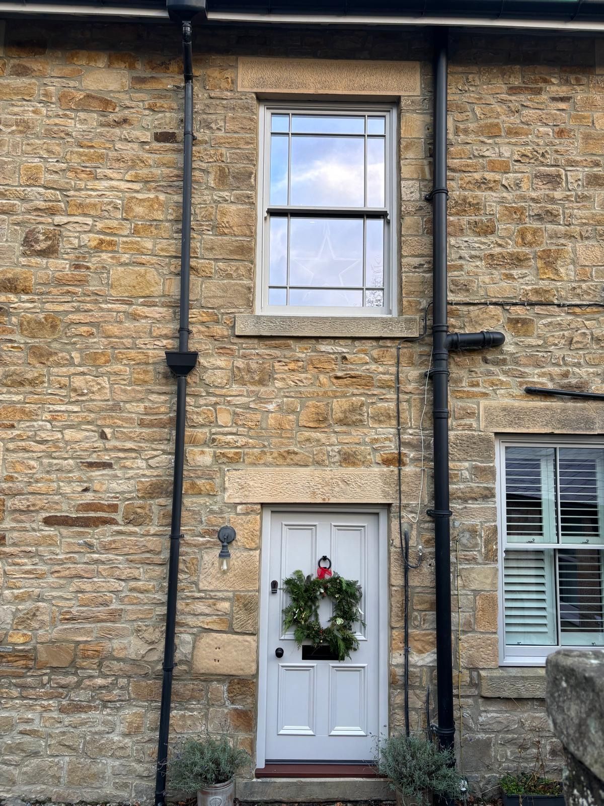 A brick building with a white door and a window