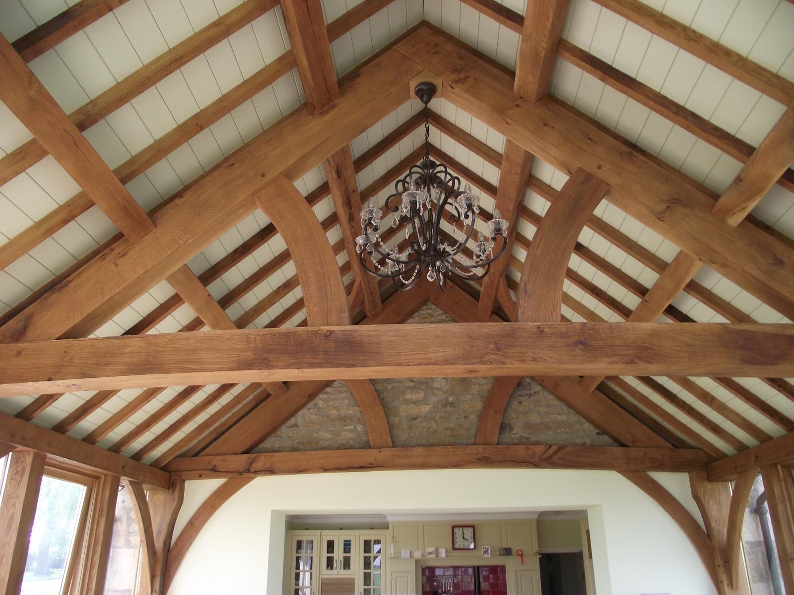 A wooden ceiling with a chandelier hanging from it