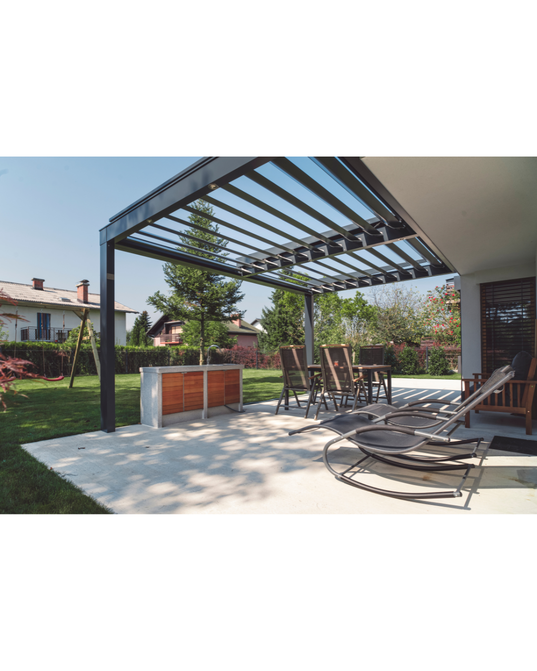 A patio with a table and chairs under a pergola.