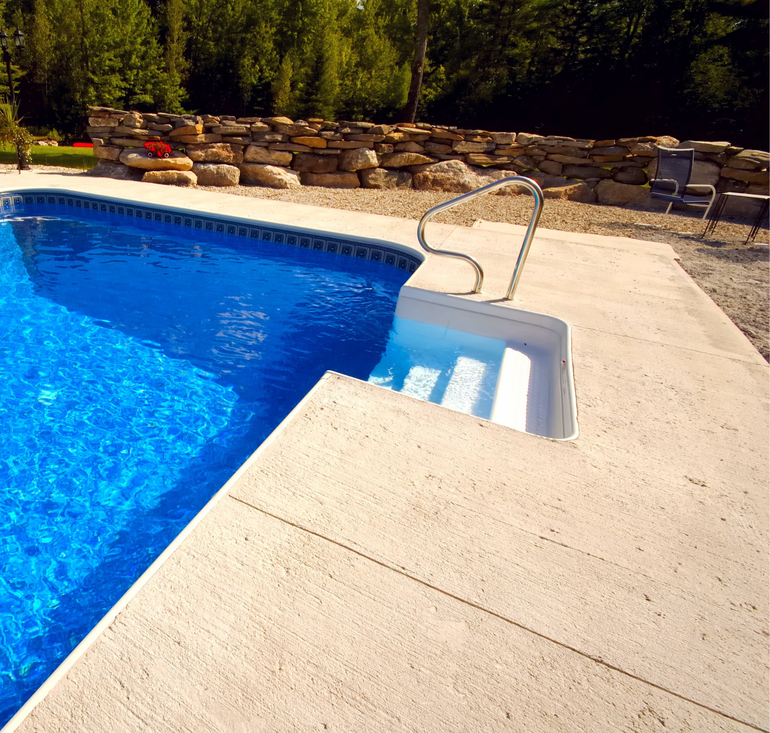 A swimming pool with stairs leading up to it
