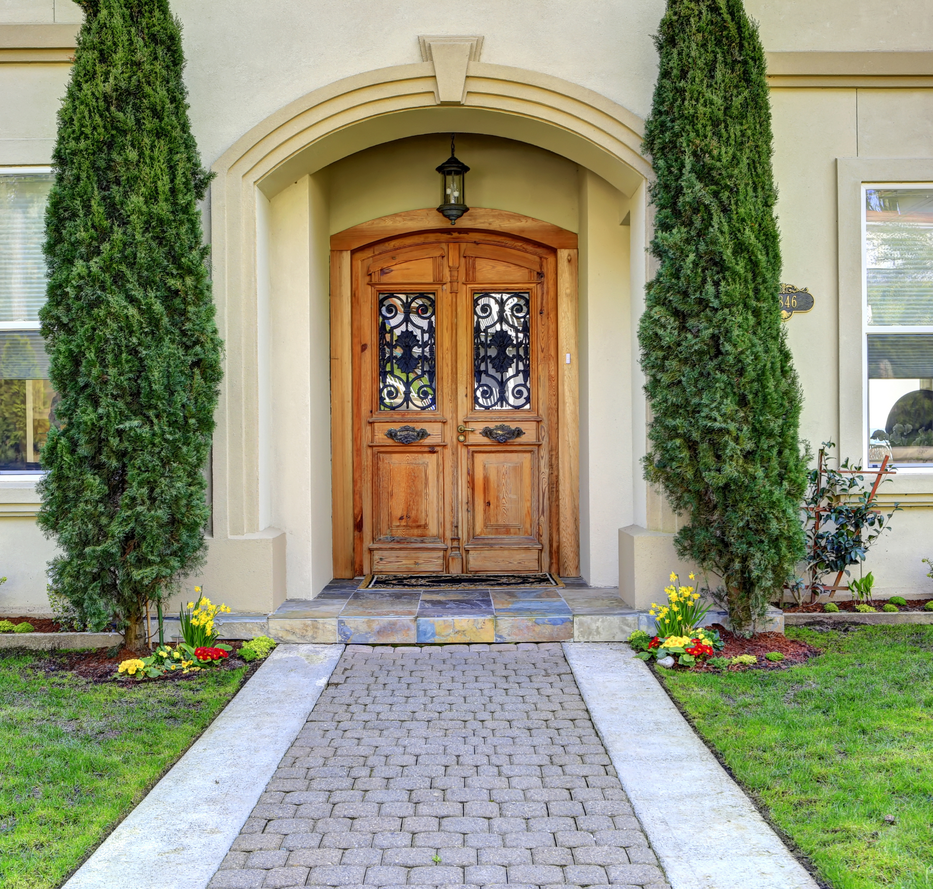 A brick walkway leads to the front door of a house