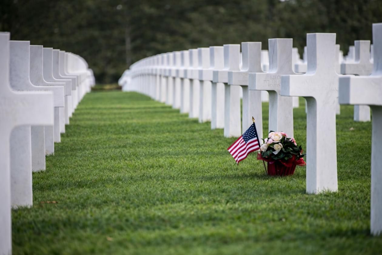 Cemetery crosses with flag and flowers, representing a funeral home and cremations Riverside, IL.