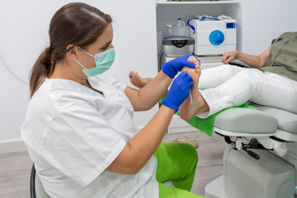 A Woman is Getting Her Feet Examined — Newcastle Foot & Ankle Clinic Charlestown In Charlestown, NSW