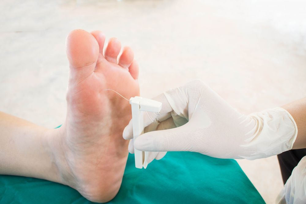 A Close Up of a Person's Foot Being Examined by a Doctor — Newcastle Foot & Ankle Clinic Charlestown In Charlestown, NSW