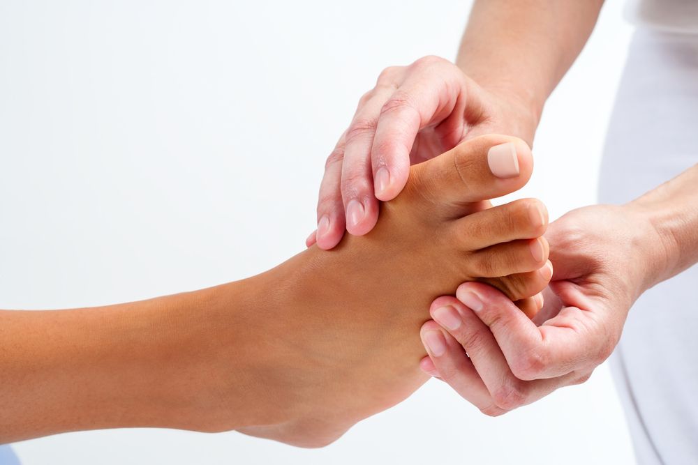 A Person is Giving a Foot Massage to Another Person — Newcastle Foot & Ankle Clinic Charlestown In Charlestown, NSW