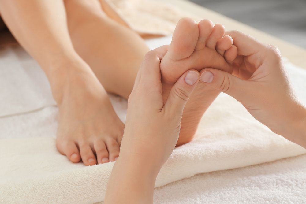 A Woman is Getting a Foot Massage in a Spa — Newcastle Foot & Ankle Clinic Charlestown In Maitland, NSW