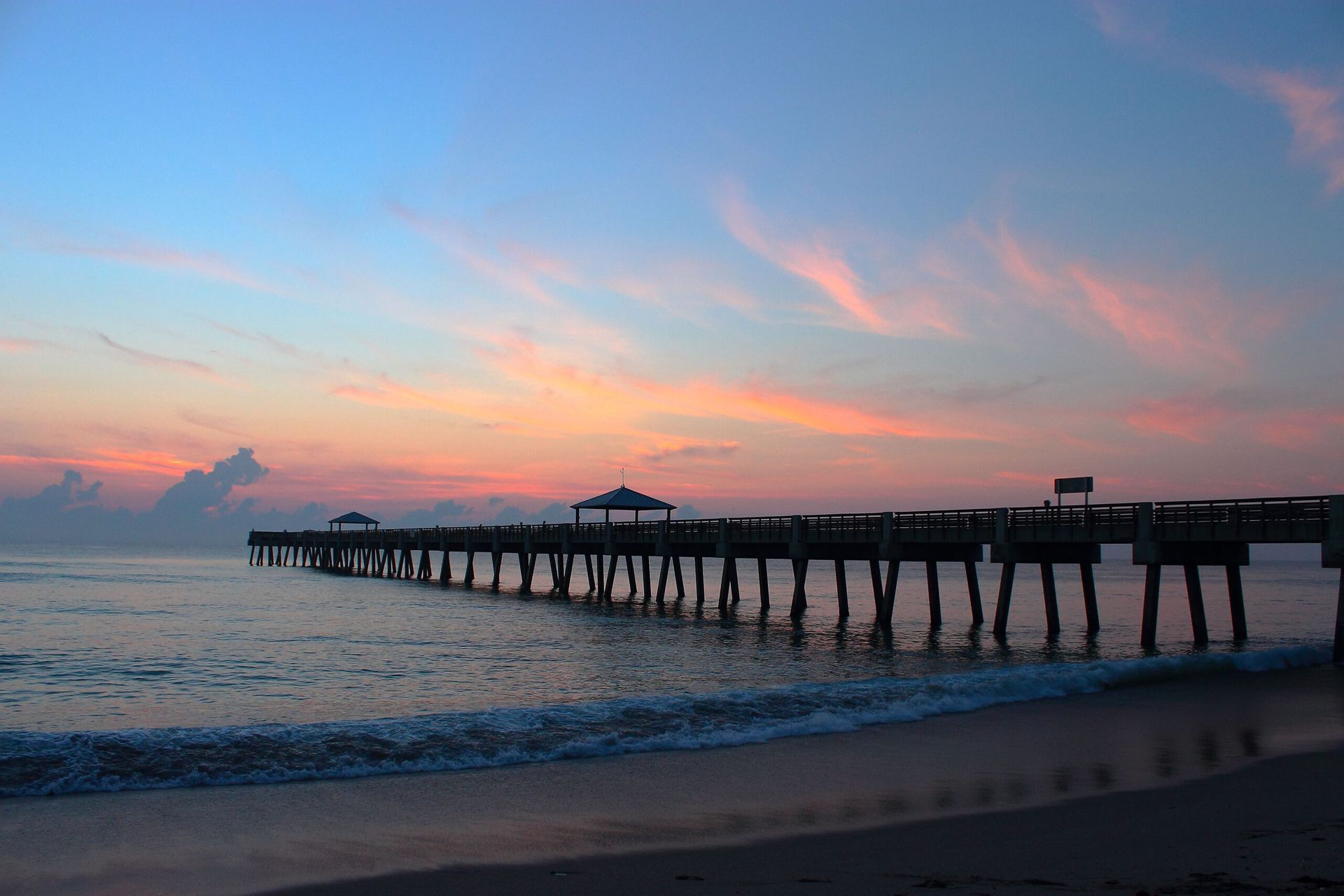 Collage of a sunny beach, palm-lined street at sunset, and a long pier over turquoise water.