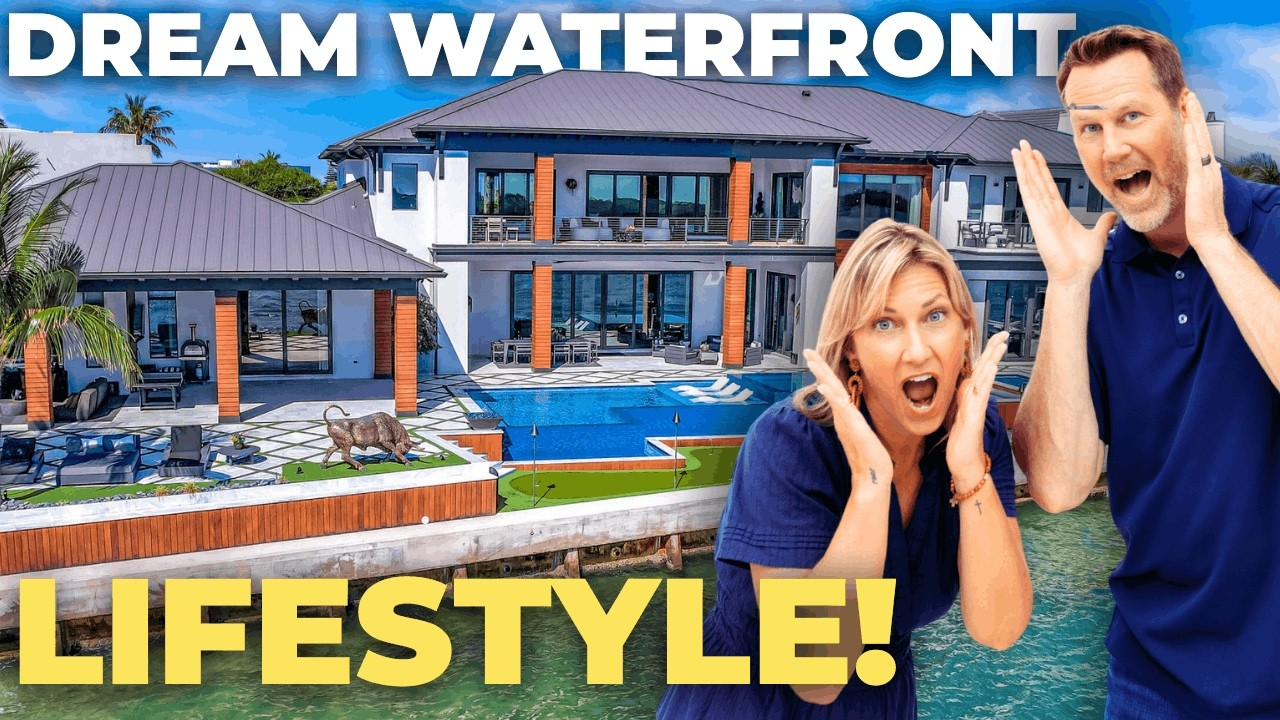 Luxury waterfront home with pool; shocked couple poses in foreground, text reads “DREAM WATERFRONT LIFESTYLE!”