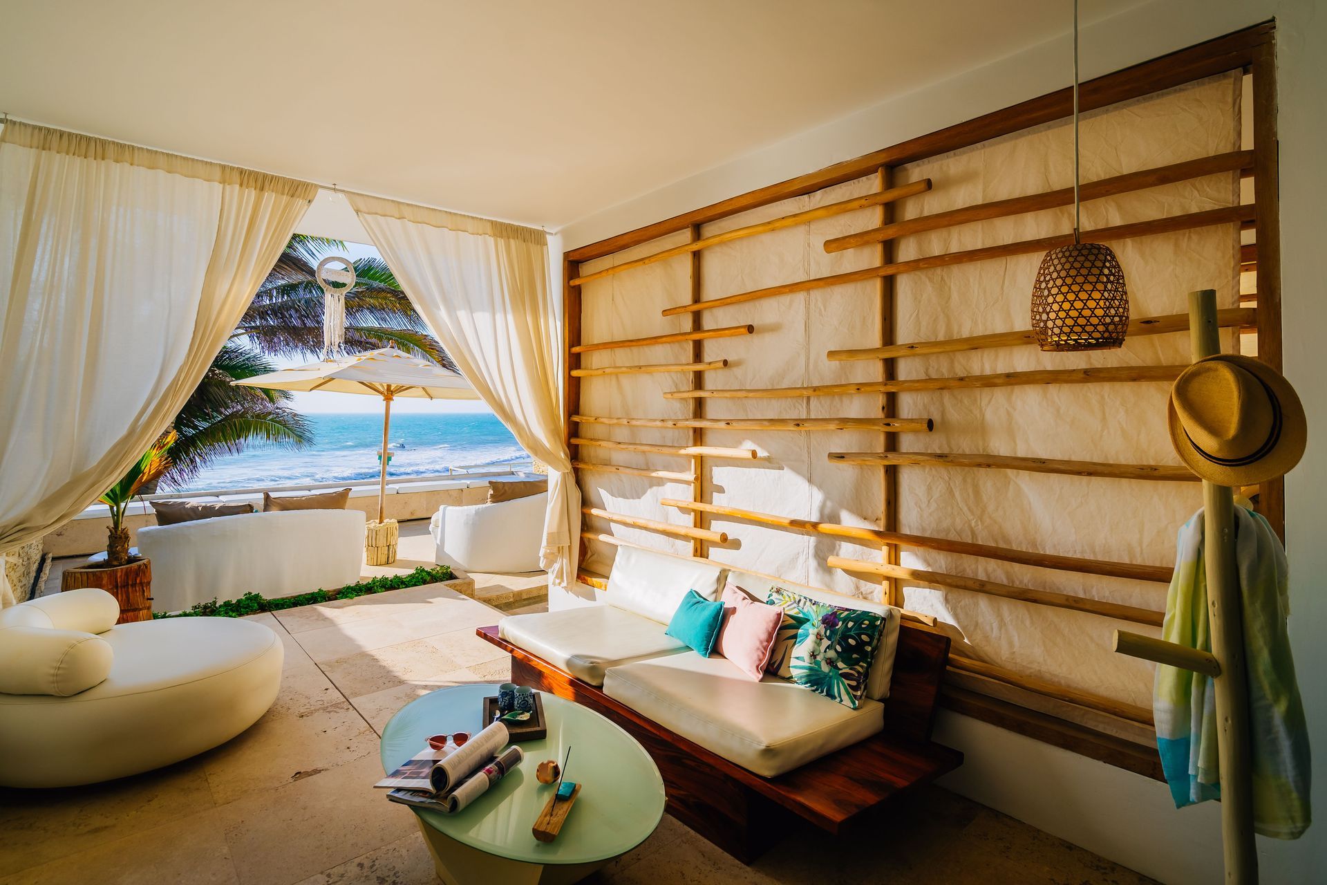 A living room with a couch and a table with a view of the ocean.