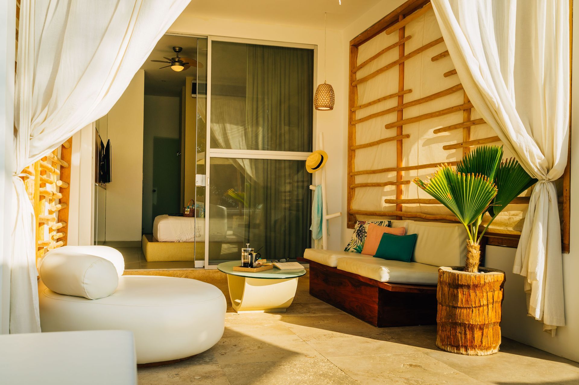 A living room with a couch , chair , table and plant.
