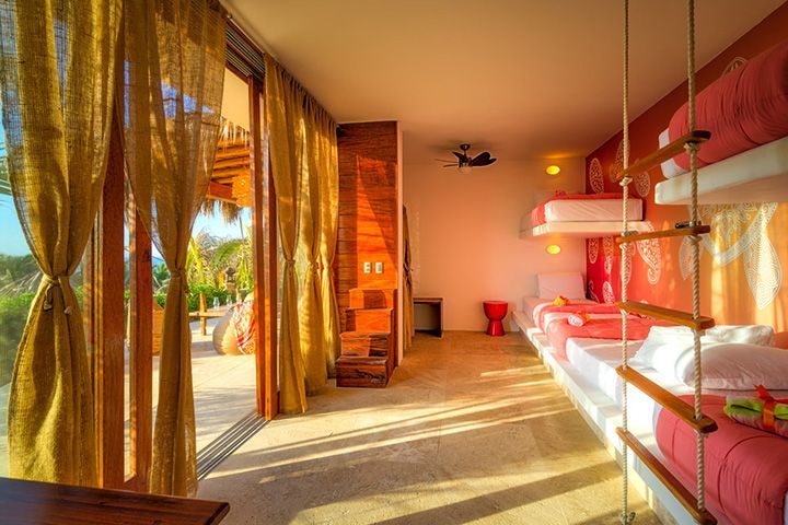 A bedroom with bunk beds and a ceiling fan.