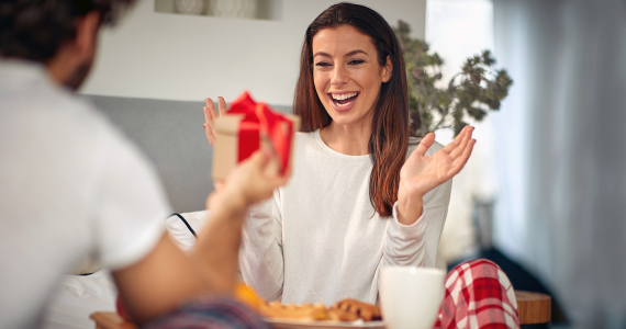 A person giving a gift — Midcoast Financial Planning Group in Tuncurry, NSW