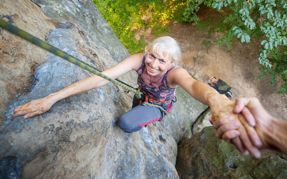 Woman Rock Climbing, Smiling — Midcoast Financial Planning Group in Tuncurry, NSW