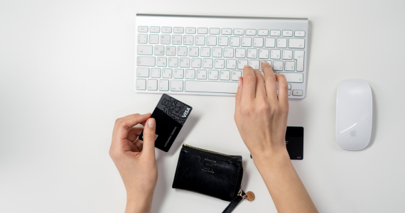 Hands Holding A Credit Card — Midcoast Financial Planning Group in Tuncurry, NSW