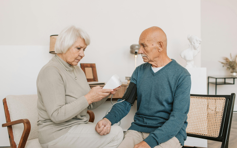 Woman Taking an Older Man's Blood Pressure — Midcoast Financial Planning Group in Tuncurry, NSW