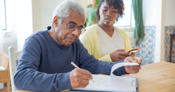 Older Adult Signing Papers — Midcoast Financial Planning Group in Tuncurry, NSW