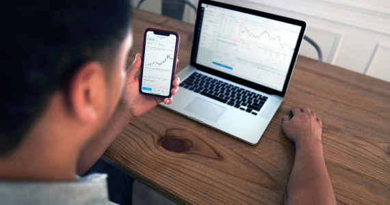 Person Viewing Stock Charts On A Laptop — Midcoast Financial Planning Group in Tuncurry, NSW