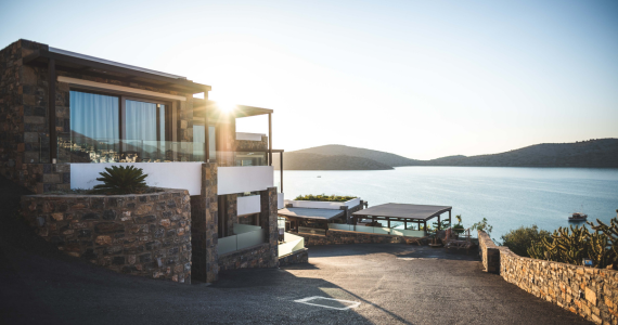 House By The Sea At Sunset, Stone Walls, Large Windows, Water View — Midcoast Financial Planning Group in Tuncurry, NSW