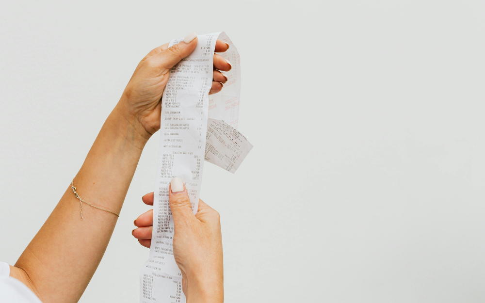Woman Holding a Long Receipt — Midcoast Financial Planning Group in Tuncurry, NSW