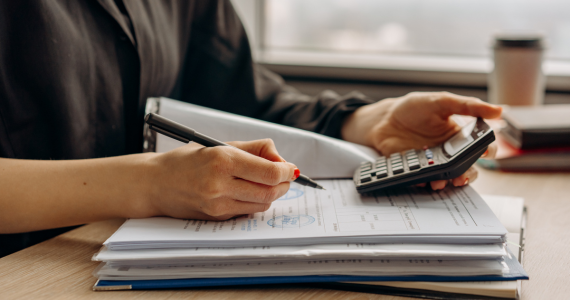 Person Calculating With A Calculator — Midcoast Financial Planning Group in Tuncurry, NSW
