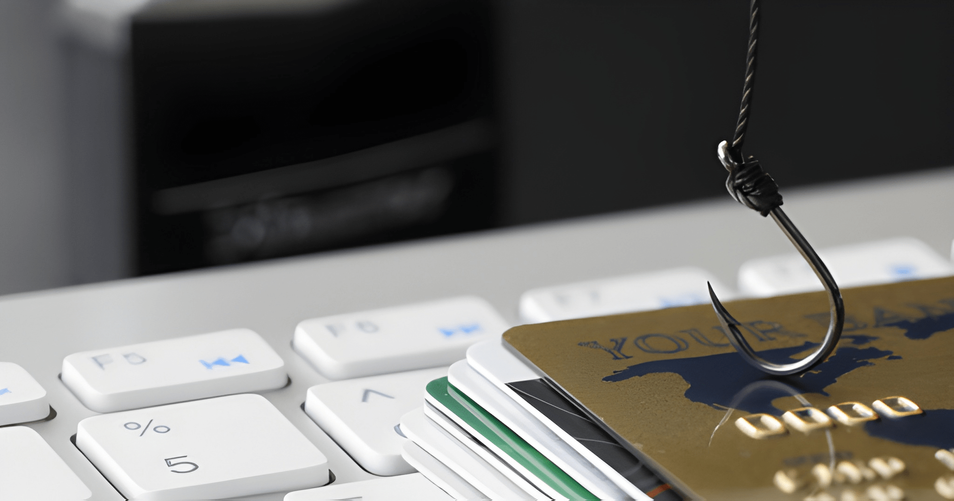 Fishing Hook Over a Stack of Credit Cards on a Computer Keyboard — Midcoast Financial Planning Group in Tuncurry, NSW