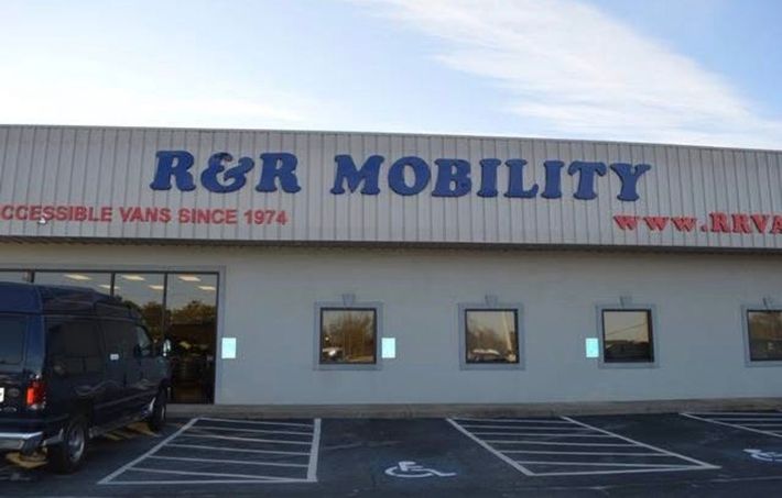 R&R Mobility storefront with accessibility van parking and office windows, exterior view