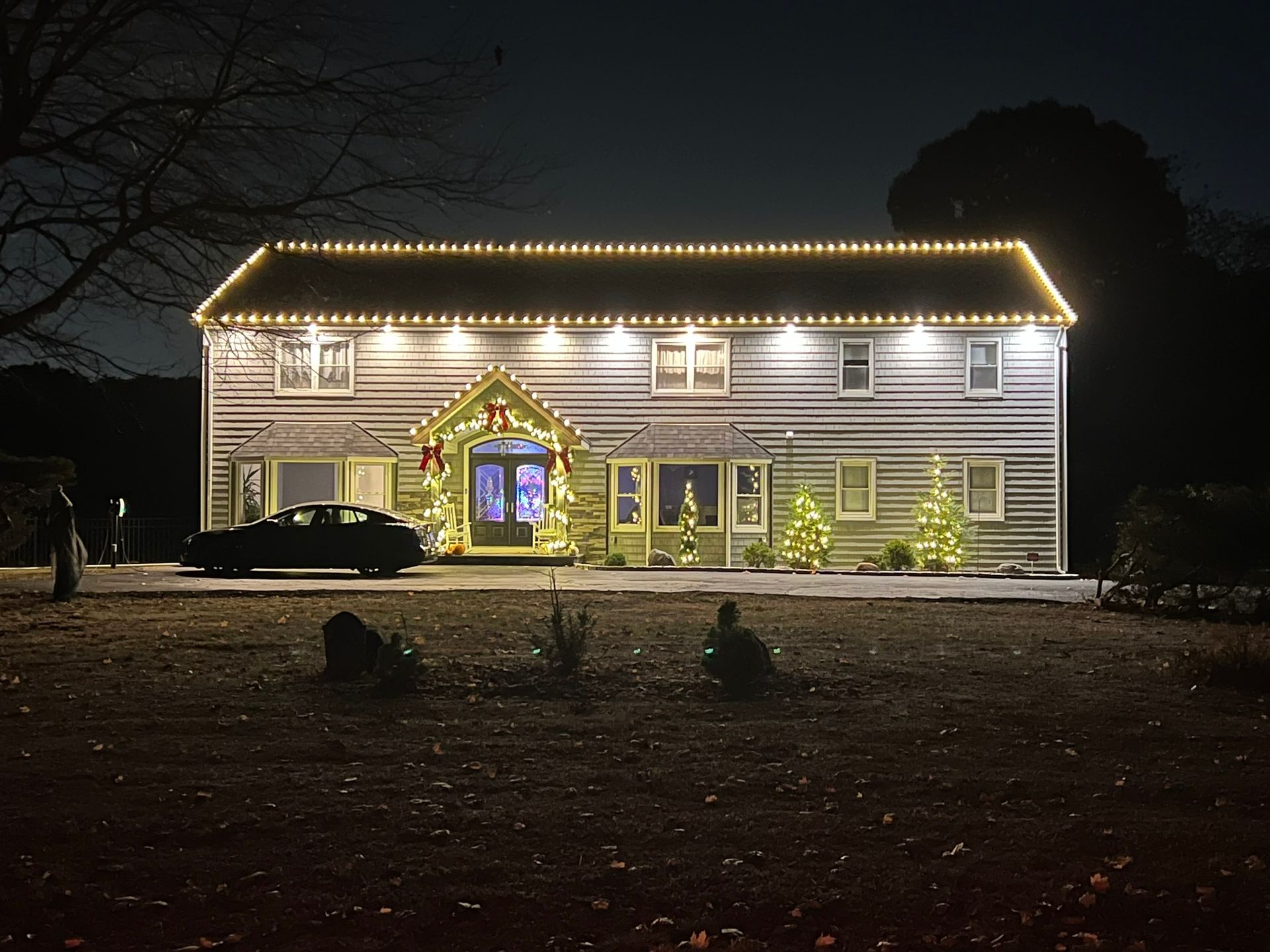 A white house with christmas lights on it