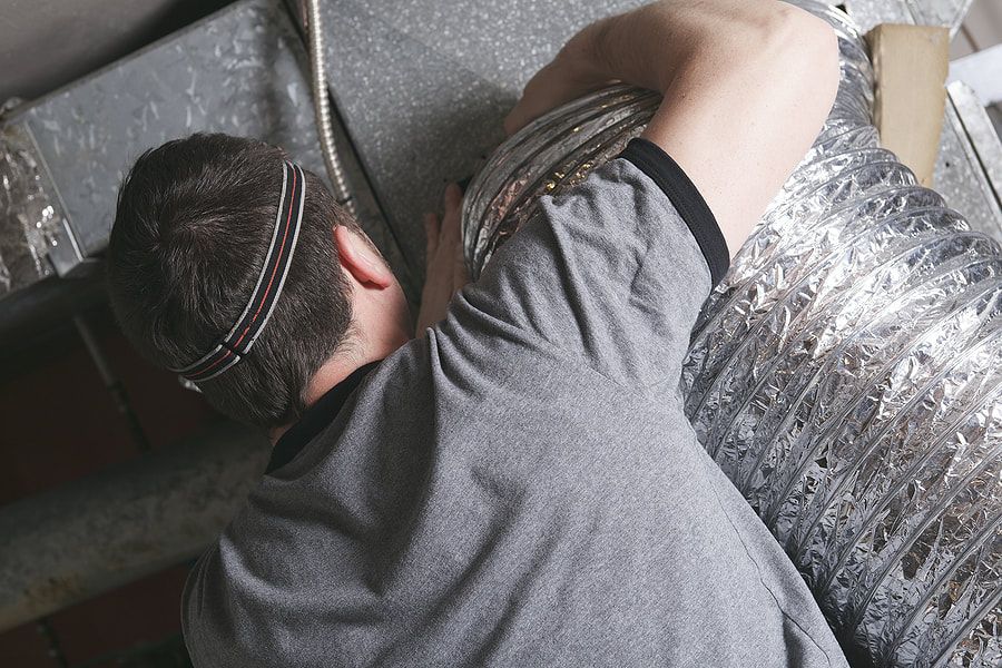 a man cleaning a large dryer duct in surprise arizona