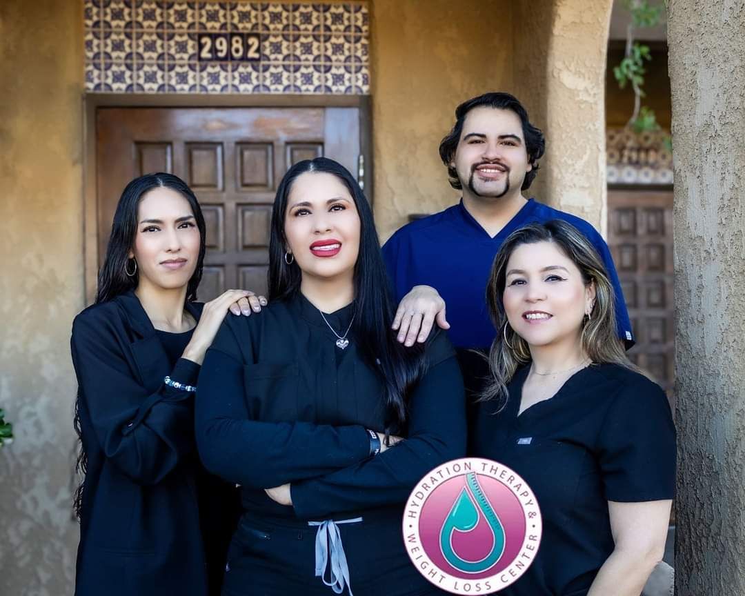 A group of people are posing for a picture in front of a building.