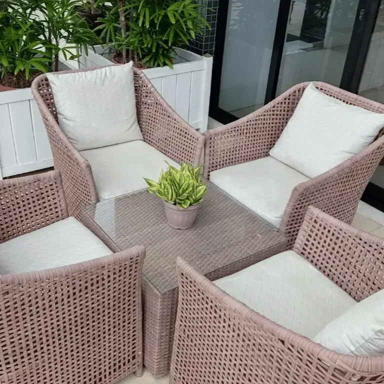 A wicker patio set with chairs and a table
