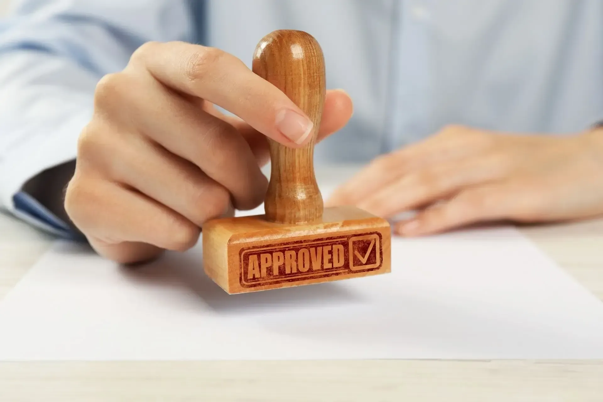 Hand stamping an approved mark on a document