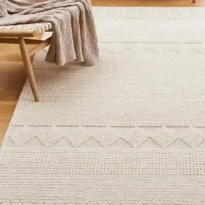 A vacuum cleaner is cleaning a carpet with steam coming out of it.