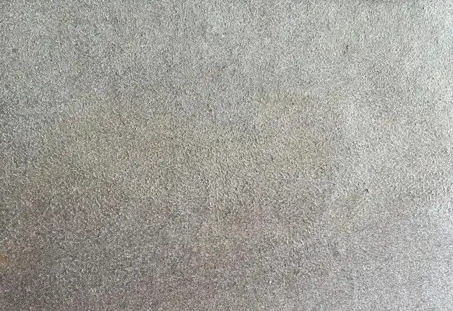 A close up of a gray carpet texture.