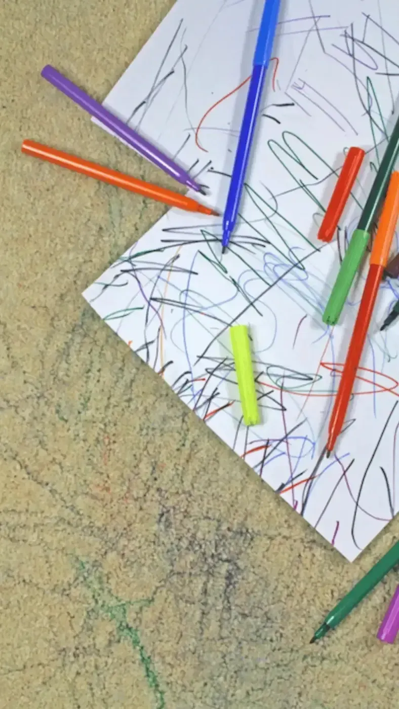 A bunch of markers are on a piece of paper