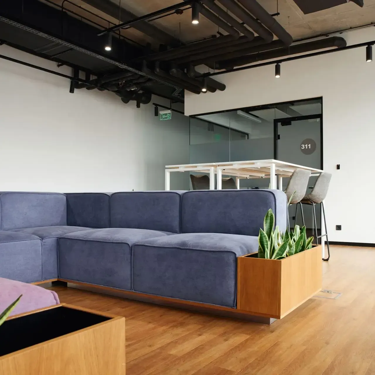 A room with orange chairs and a tv on the wall