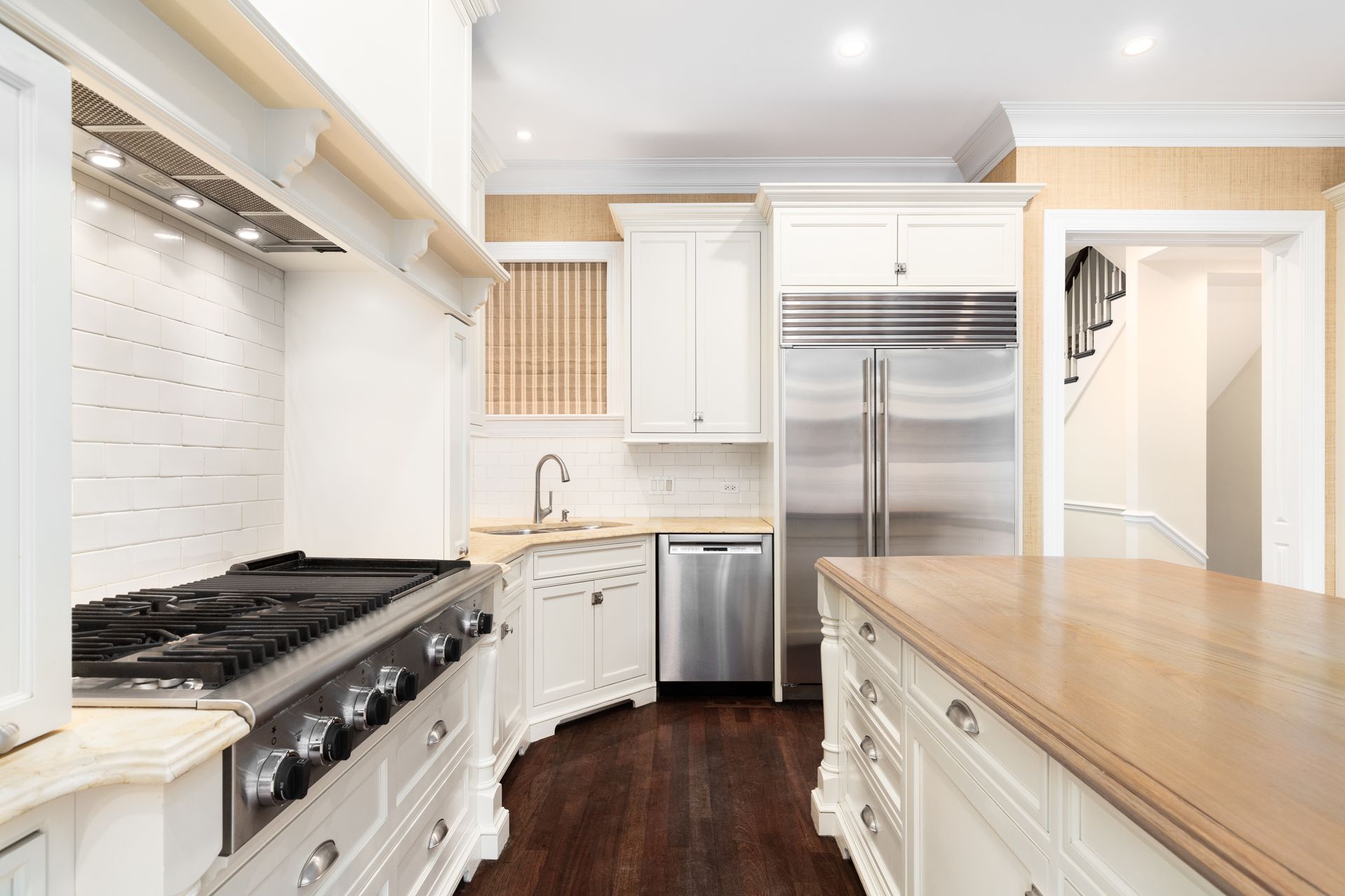 Modern kitchen with stainless steel, white cabinets, granite, and range hood. Modern kitchen with stainless steel, white cabinets, granite, and range hood.