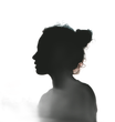 Black silhouette profile of a person with curly hair against a white background
