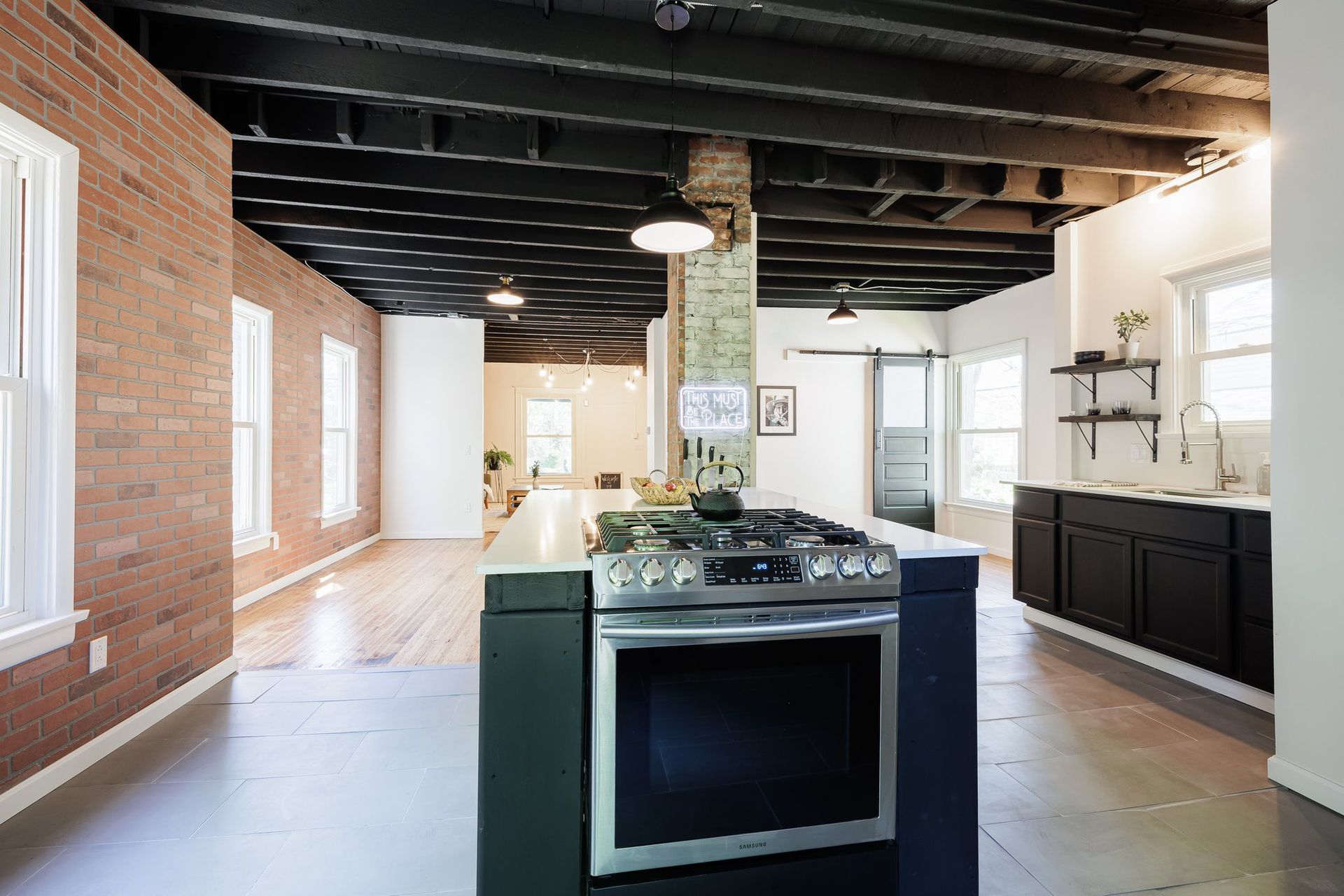 A kitchen with a large island and a stove.
