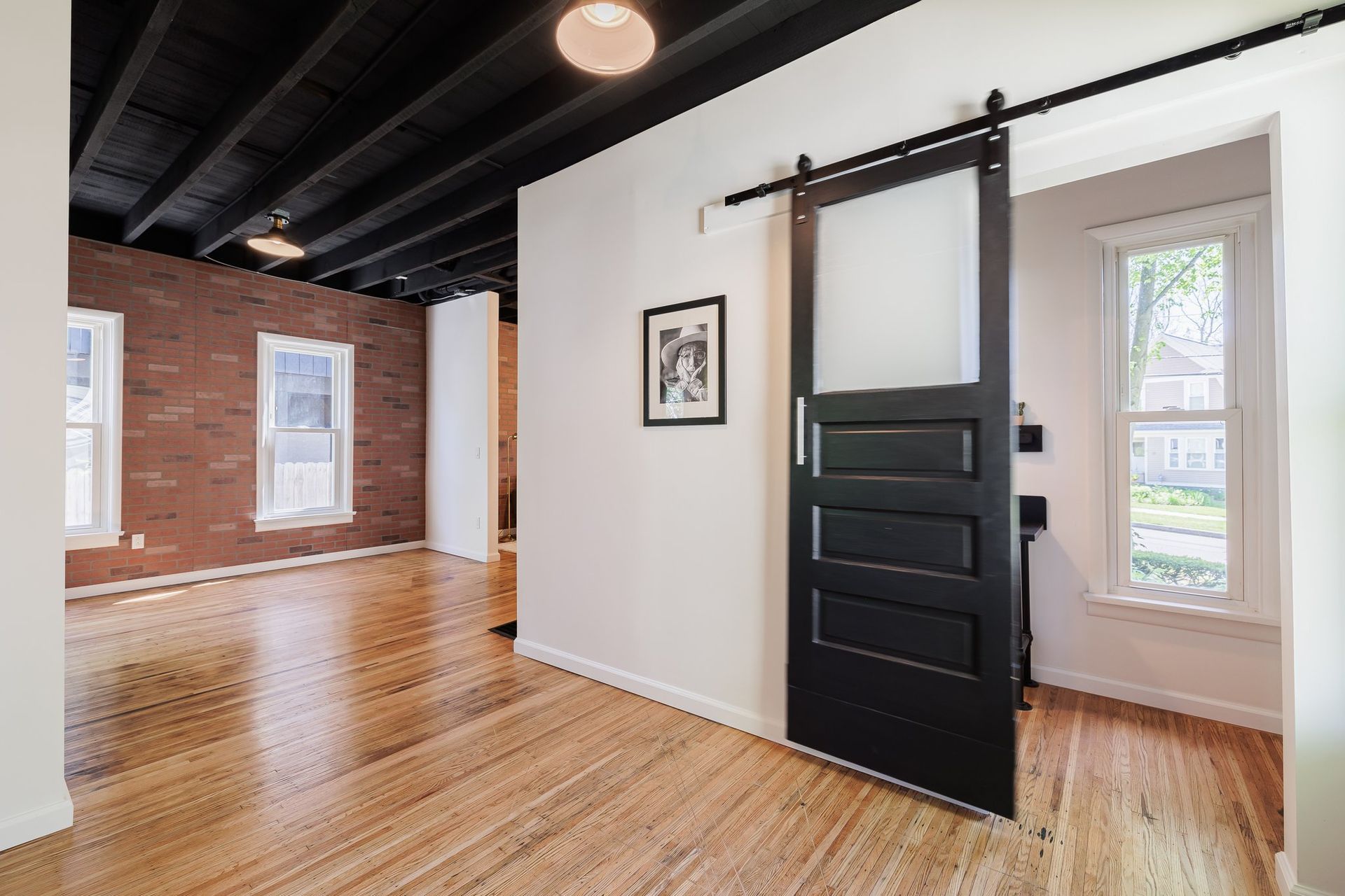 There is a sliding barn door in the middle of the room.