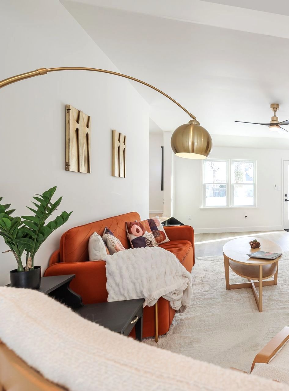 A living room with a couch and a lamp