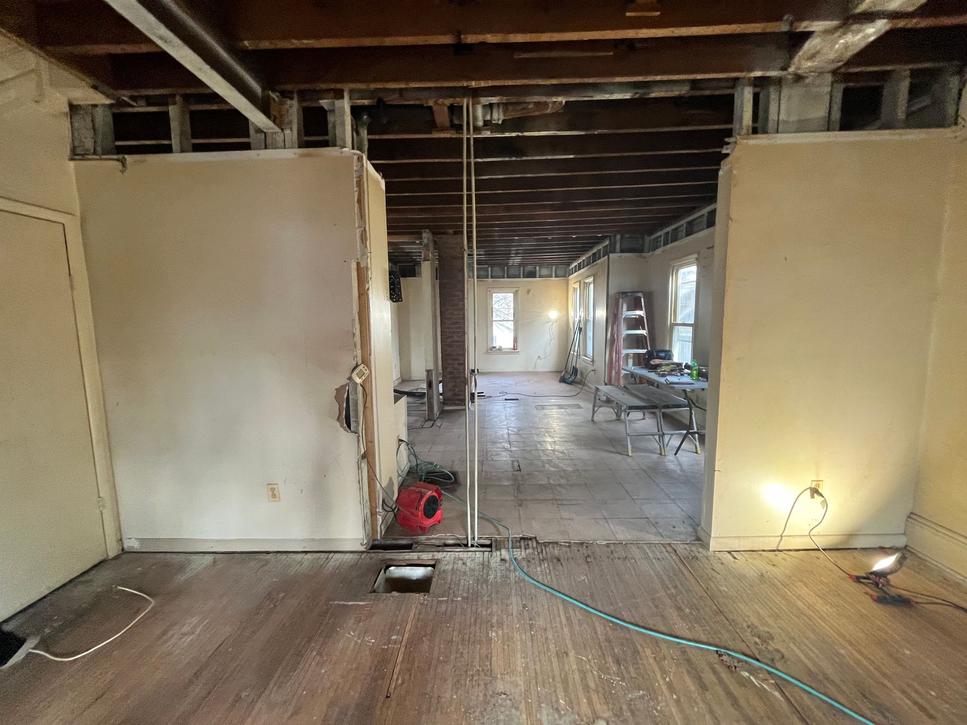 An empty room with a vacuum cleaner in the middle of it.